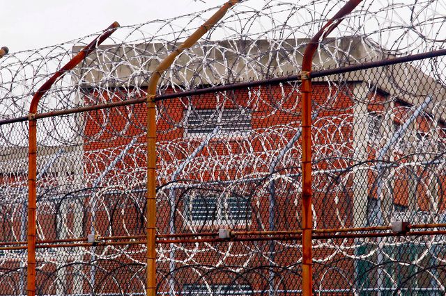 A security fence surrounds inmate housing on the Rikers Island correctional facility in New York in a photograph on October 18, 2017.